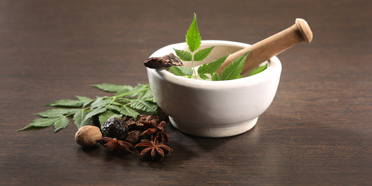 pesel and mortar with herbs and spices inside and on the side