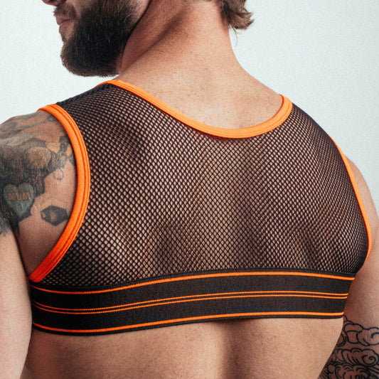 Man wearing a mesh tank top with orange trim on a plain background