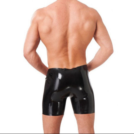 man wearing black latex bermuda shorts on white background. image 2. back view.