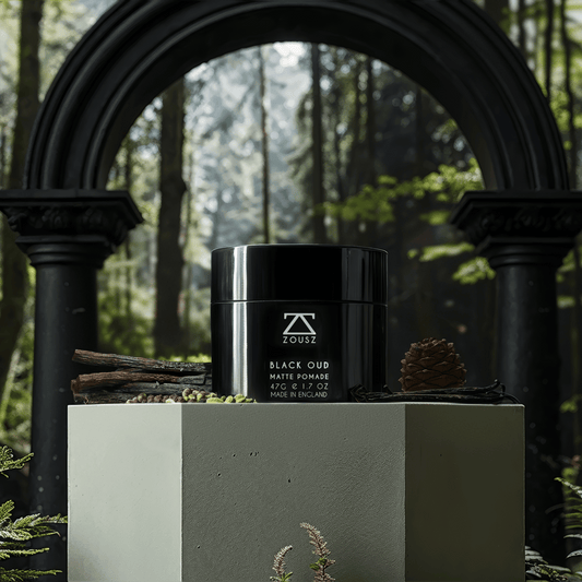 Jar of Pomade sitting on a plinth in front of an arch with some grennery.