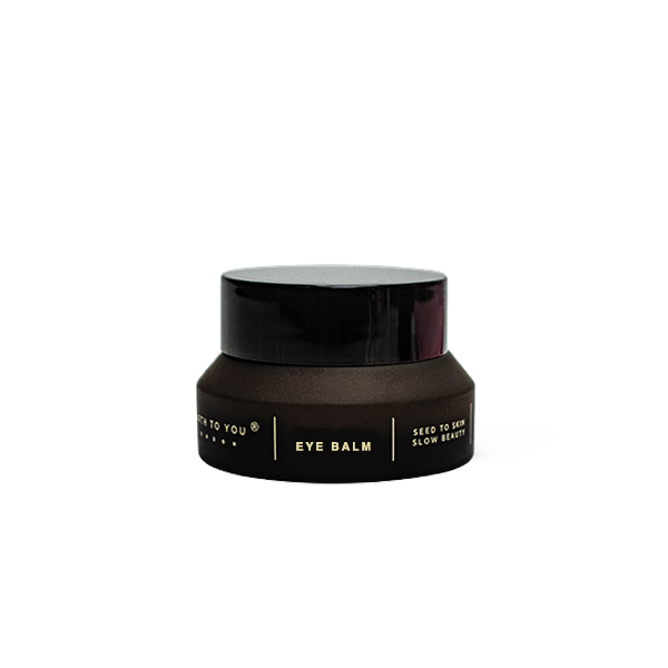 Black eye balm jar on a white background