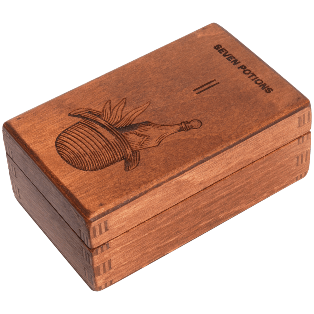 Wooden box with engraved design and 'Seven Potions' text on a white background