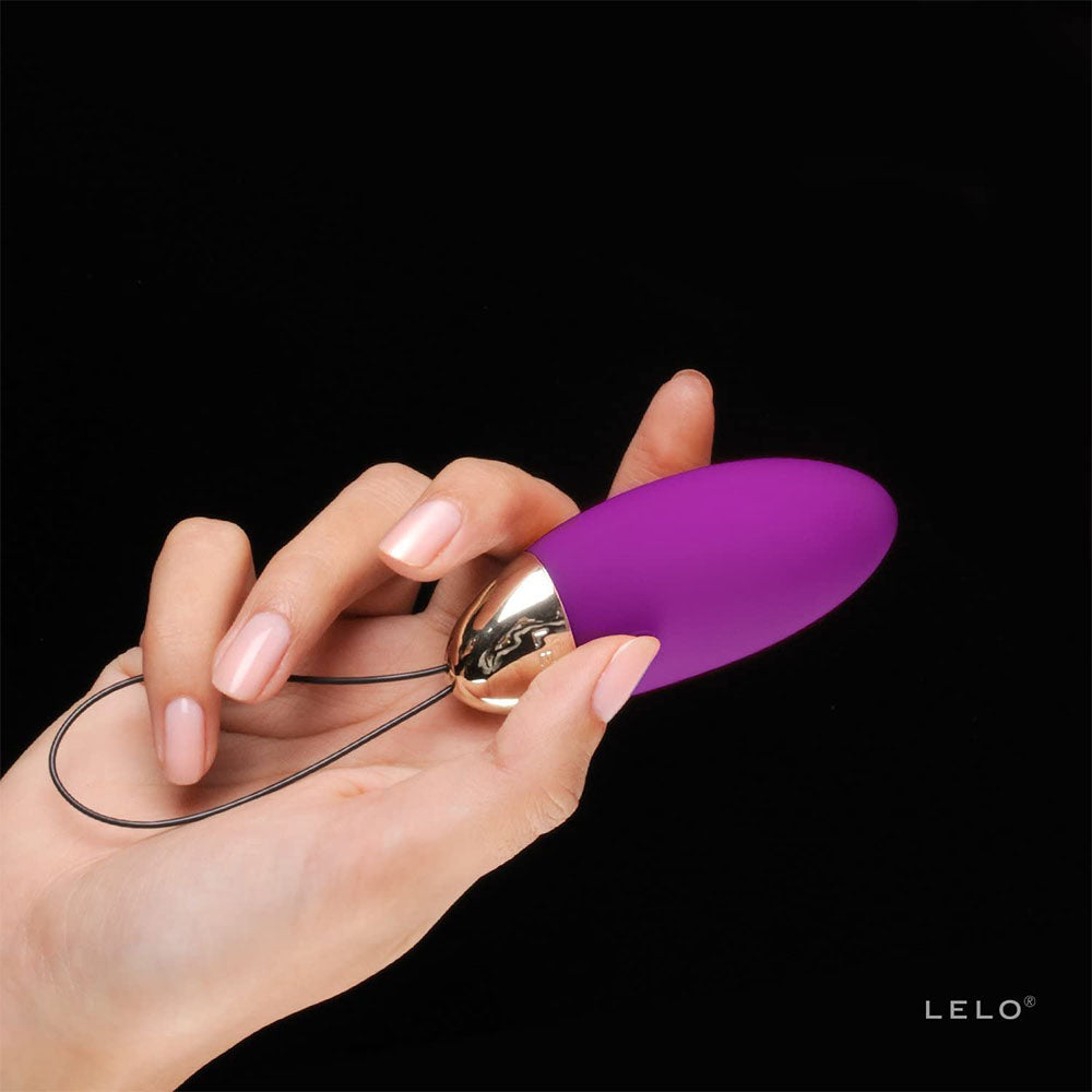 hand holding Deep Rose Vibrating Bullet on black background. image 3
