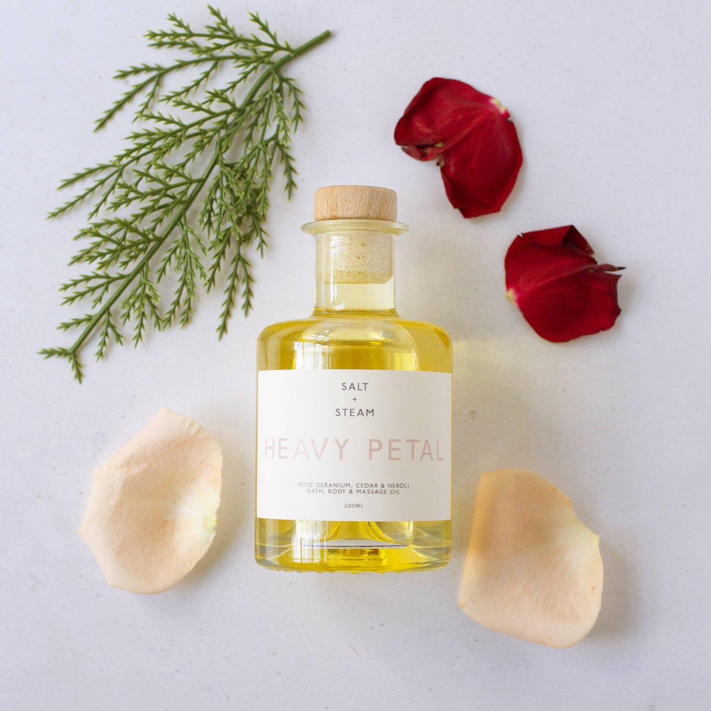 Jar of oil with flowers and herbs
