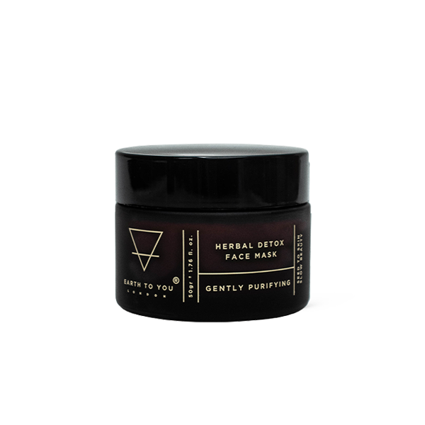 Black jar of herbal detox face mask with brand name on a white background