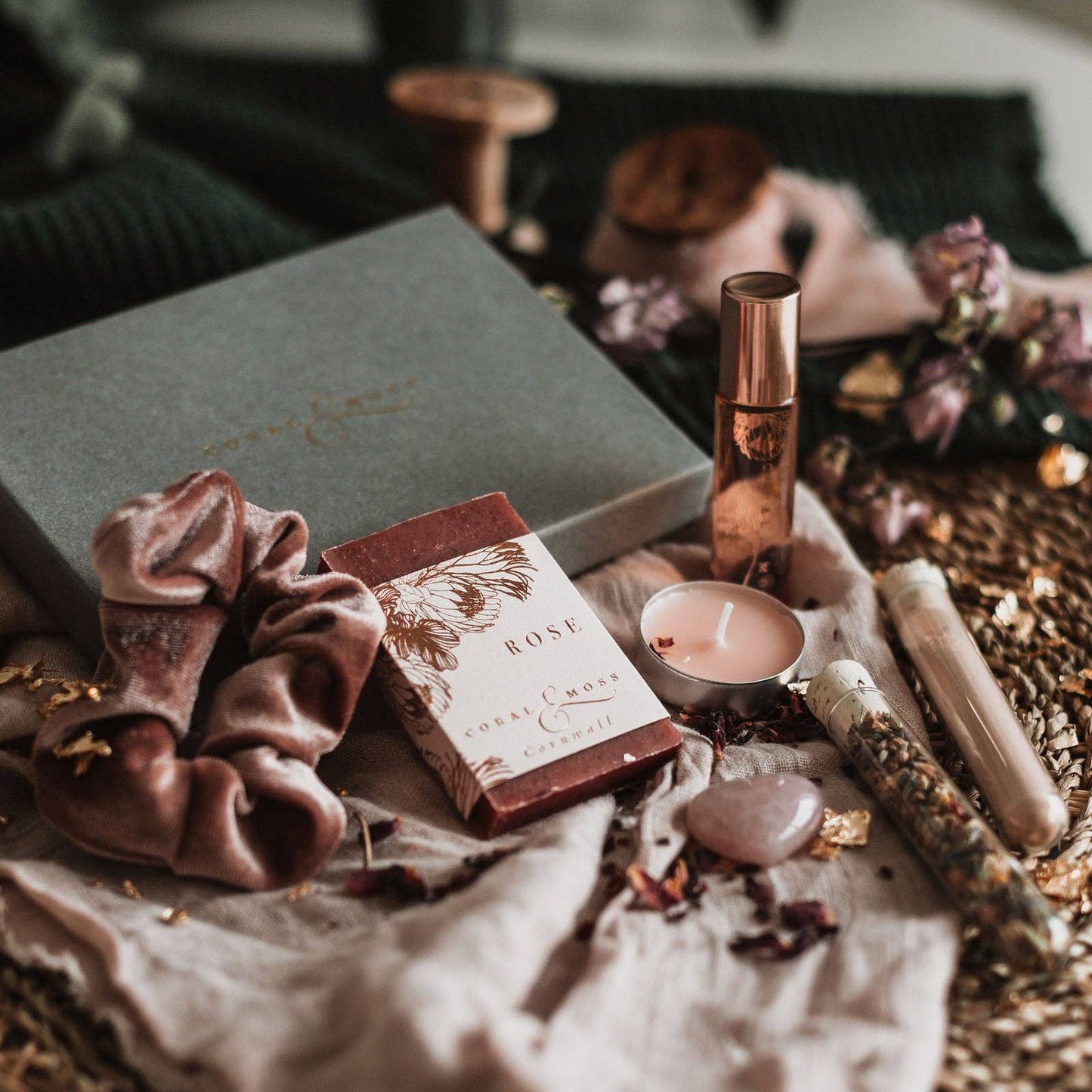 Closed green gift box with items in front