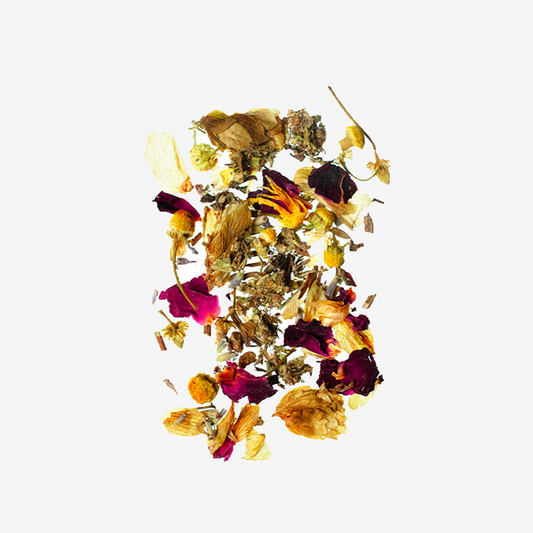 Colorful assortment of dried flowers and herbs on a white background