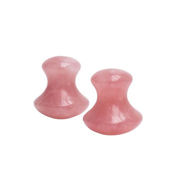 Two pink stone plugs on a white background