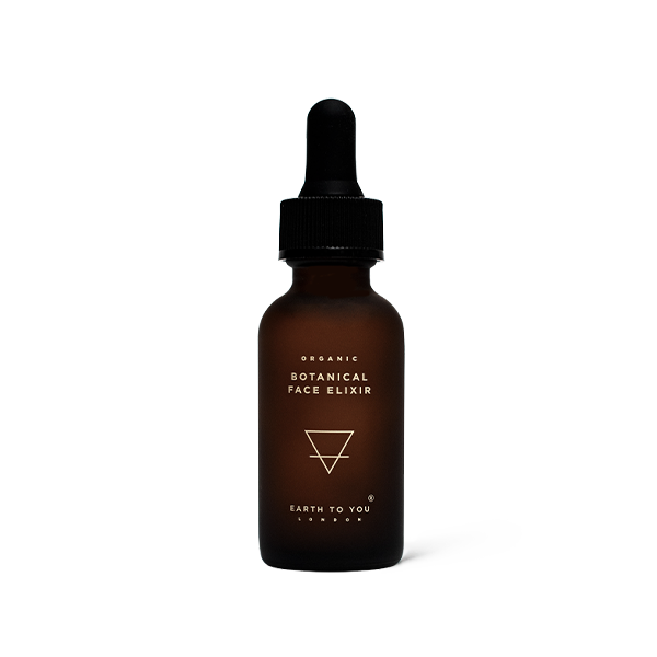 Brown bottle of organic botanical face elixir with dropper on a white background