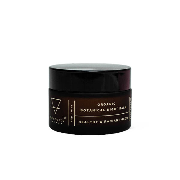 Black jar of organic botanical night balm on a white background