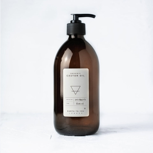 Brown bottle with pump and white label on a white background
