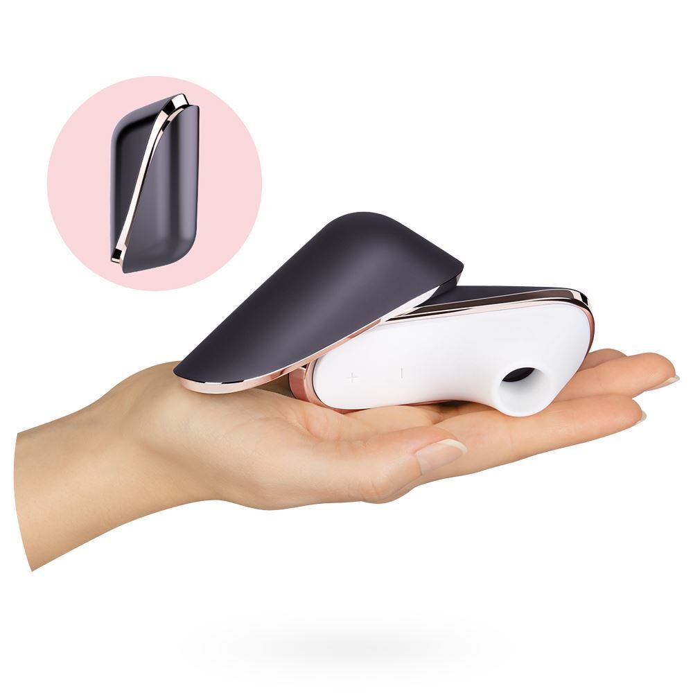 hand holding Purple Traveler Clitoral Vibrator on white background. image 3