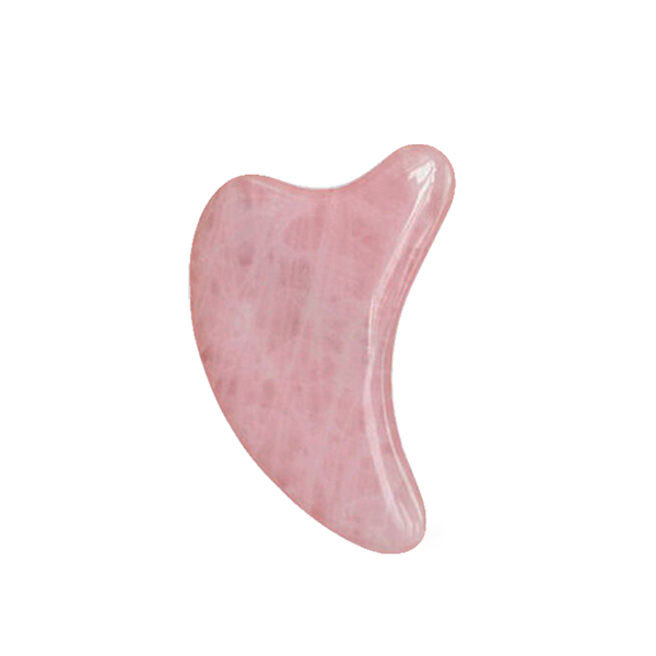 Pink gua sha tool on a white background