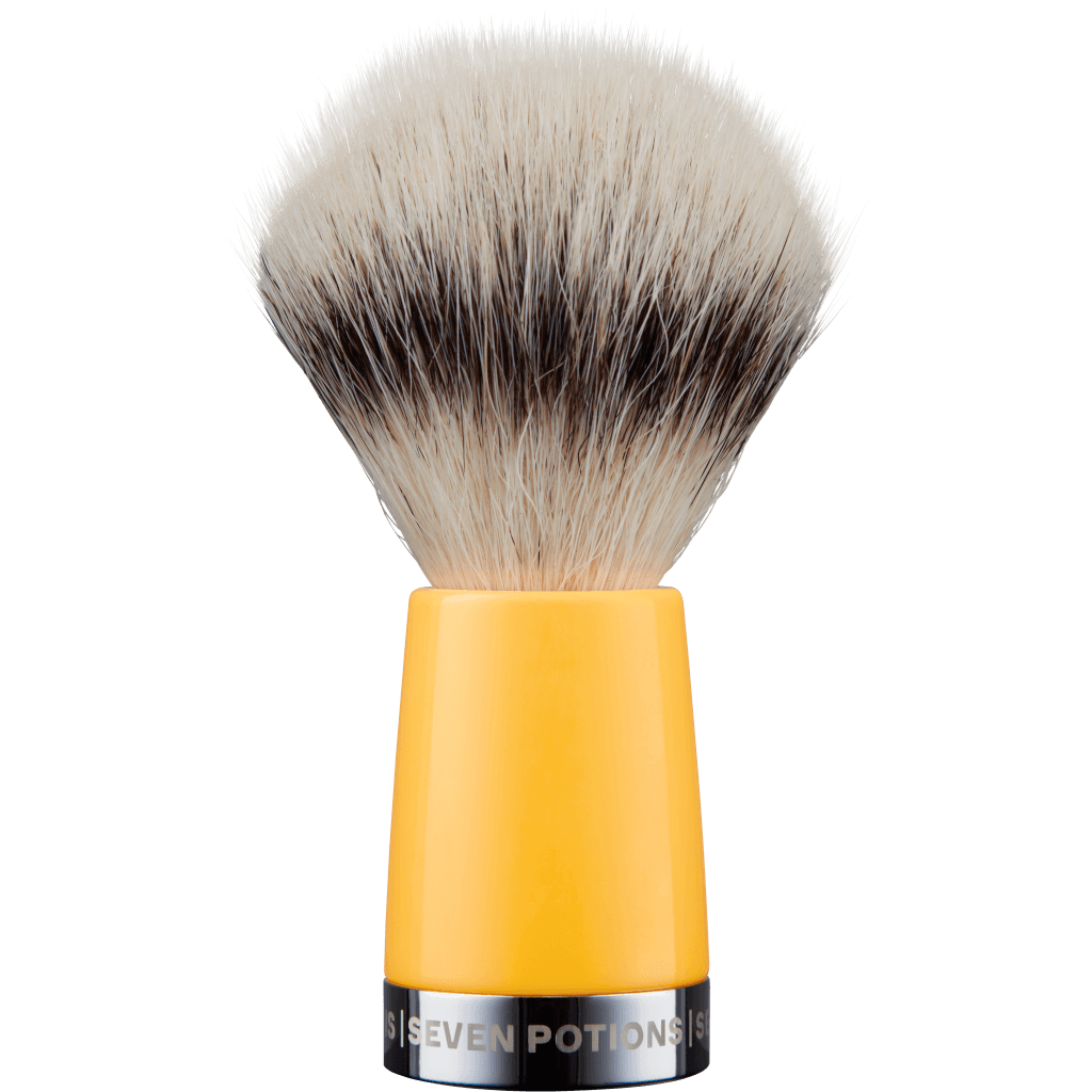 Shaving brush with yellow handle and black bristles on a white background