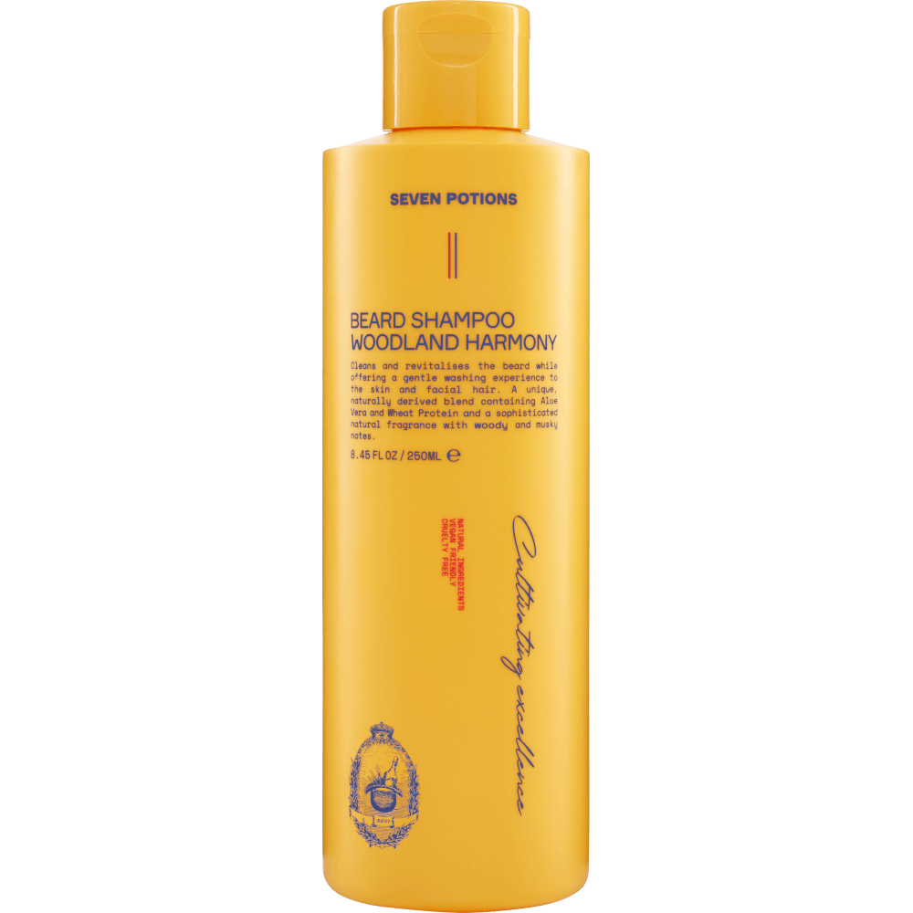 Yellow bottle of Seven Potions Beard Shampoo on a gray background