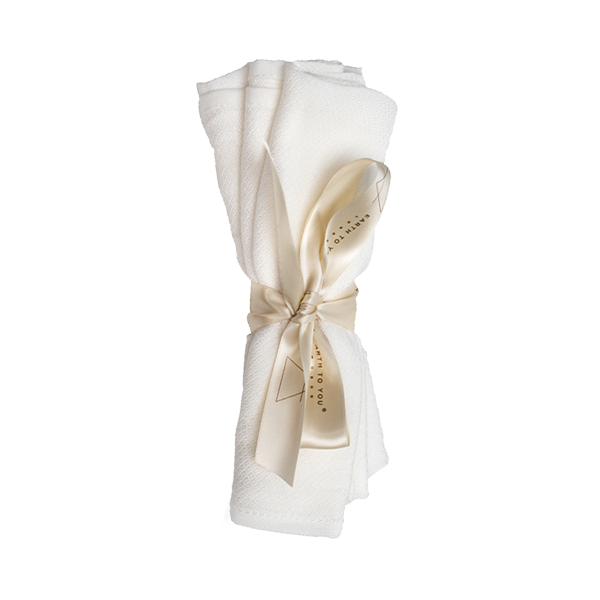 White towel with a gold ribbon on a white background