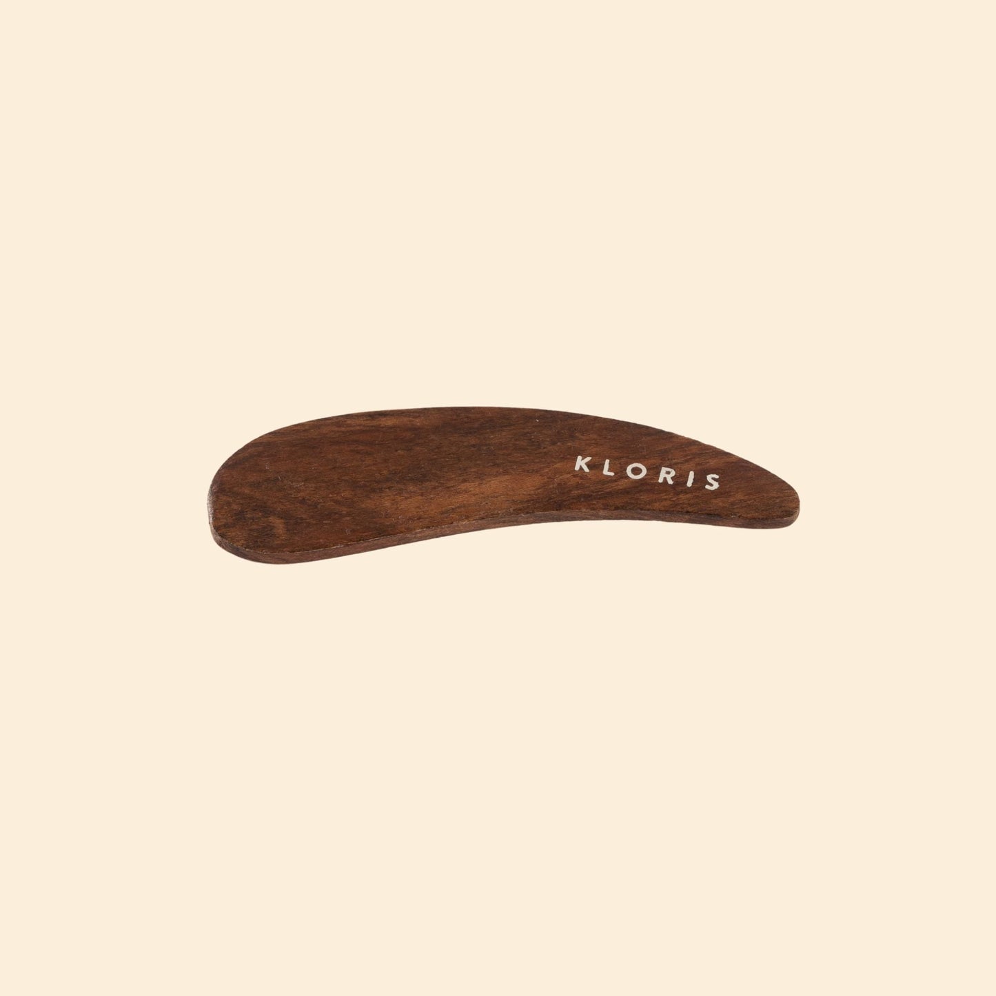 Wooden tool with 'KLORIS' branding on a beige background