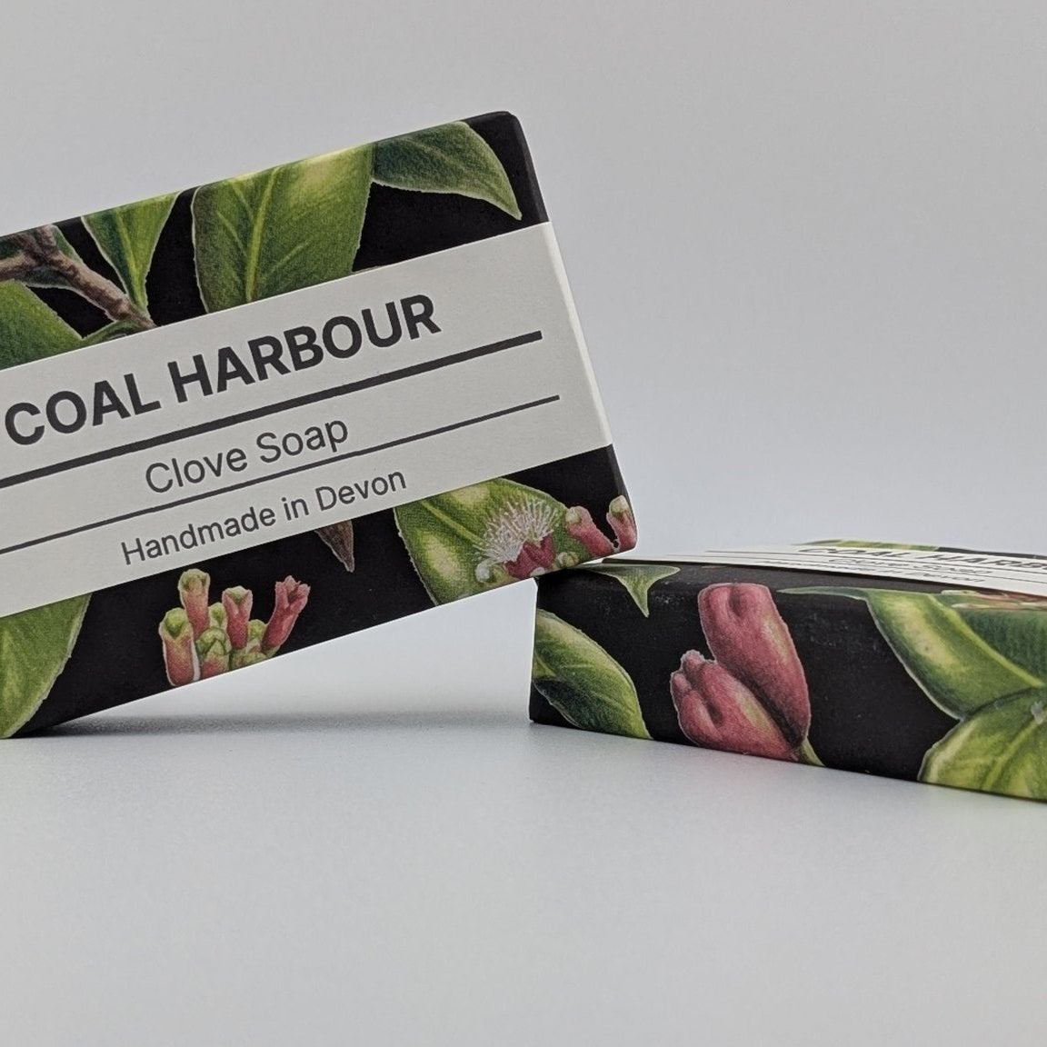 Two bars of Coal Harbour Clove Soap with a floral design on a white background