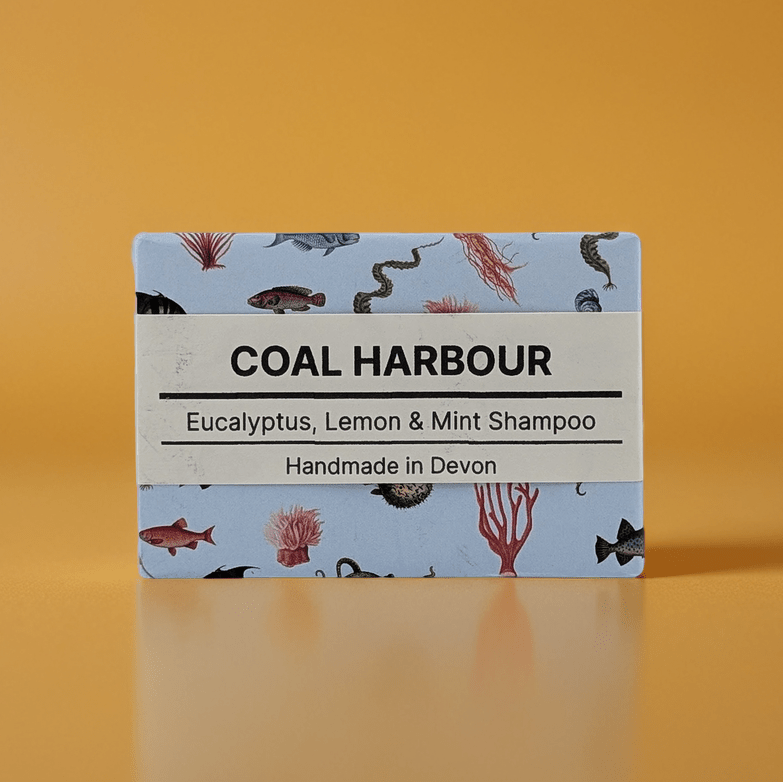 Coal Harbour shampoo bar packaging with a blue label on an orange background