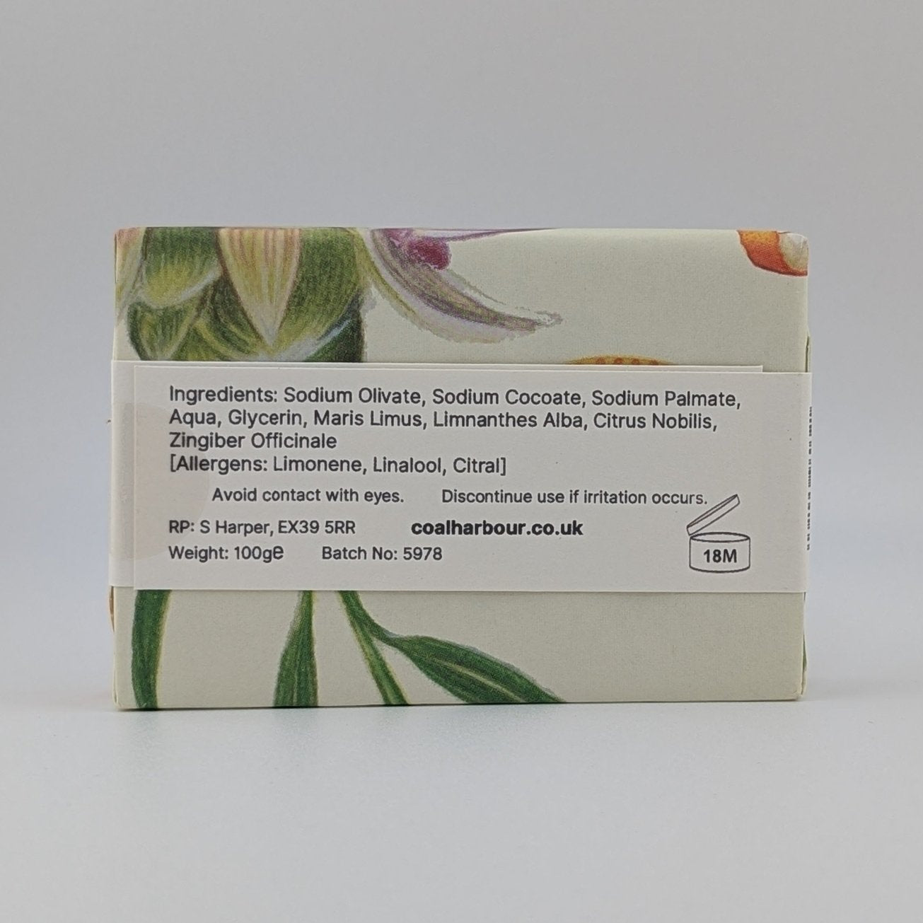 Bar of soap with botanical design on a white background