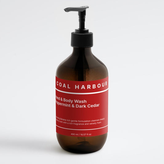 Bottle of Coal Harbour hand and body wash with a red label on a white background