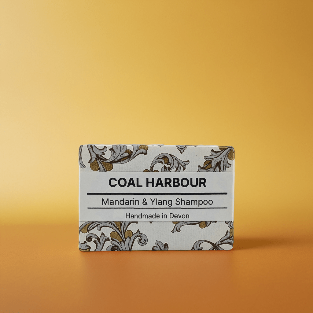 Box of Coal Harbour Mandarin & Ylang Shampoo on a gradient orange background