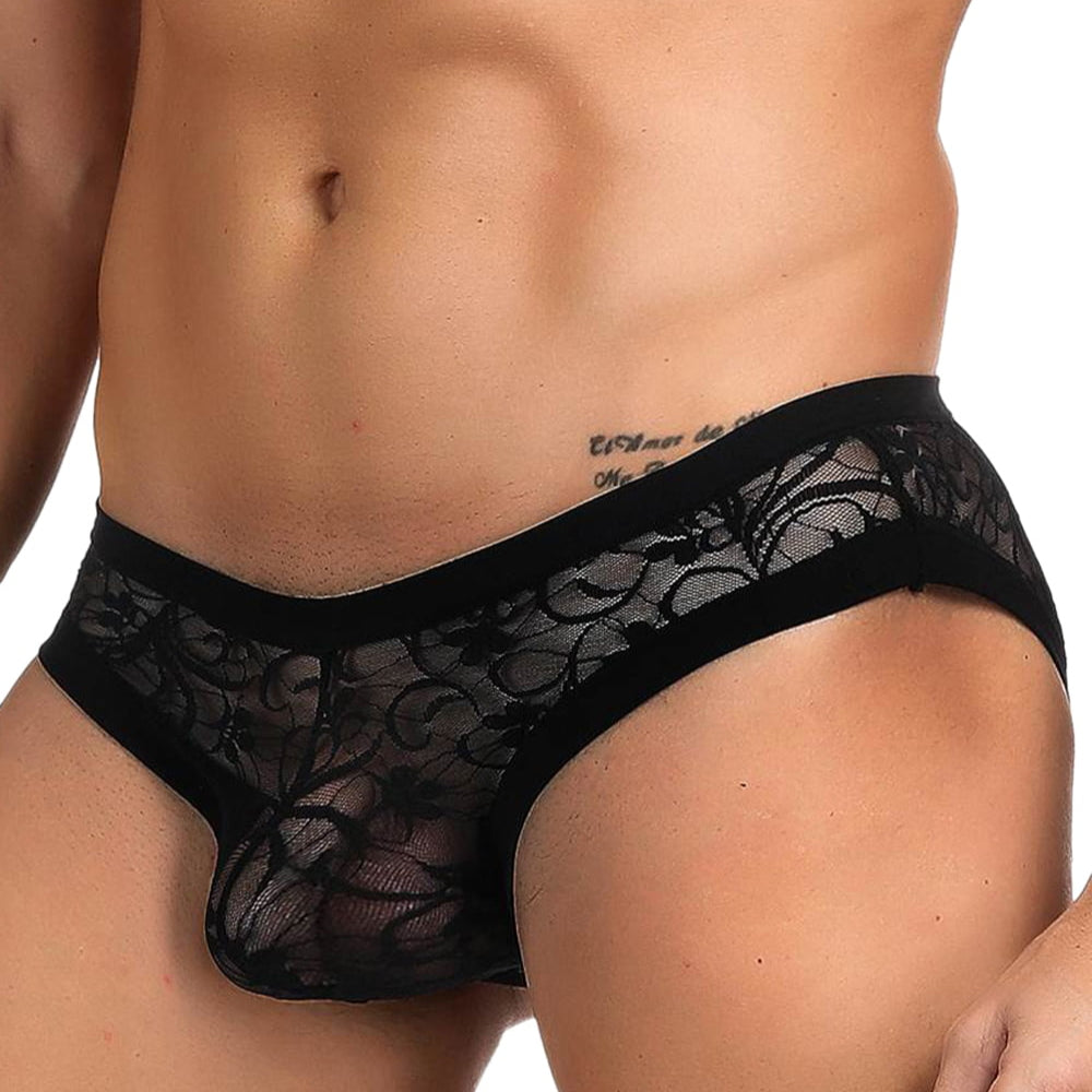man wearing short black briefs on white background, side view.