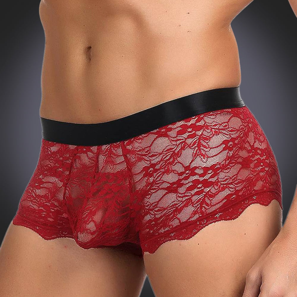 man wearing red briefs on grey background, side view