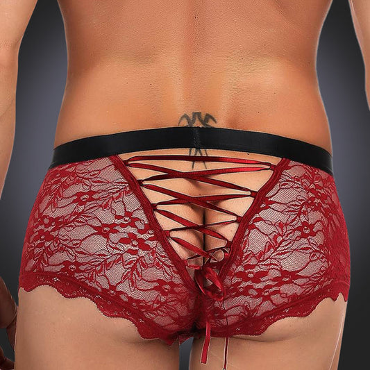 man wearing red briefs on grey background, back view