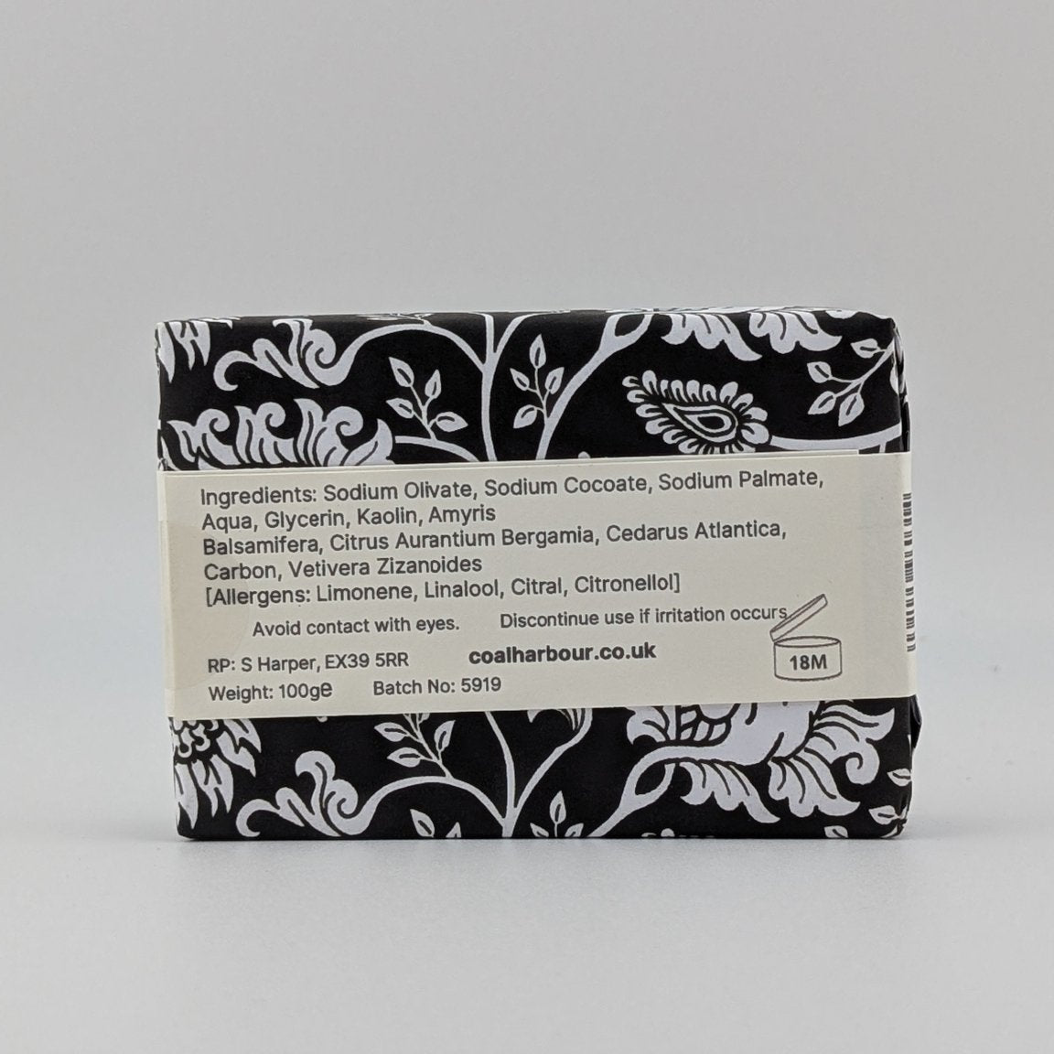 Bar of soap with black and white label on a gray background