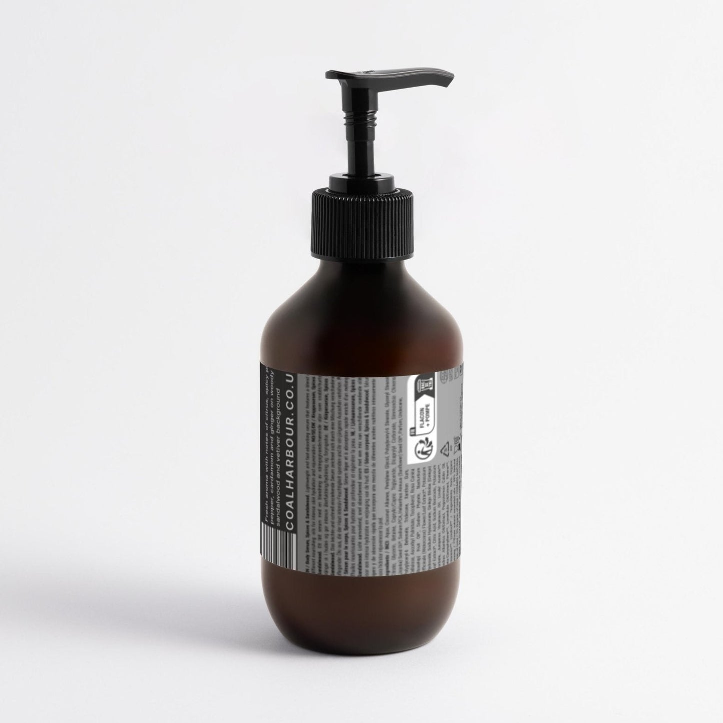 Brown bottle with pump and label on a white background