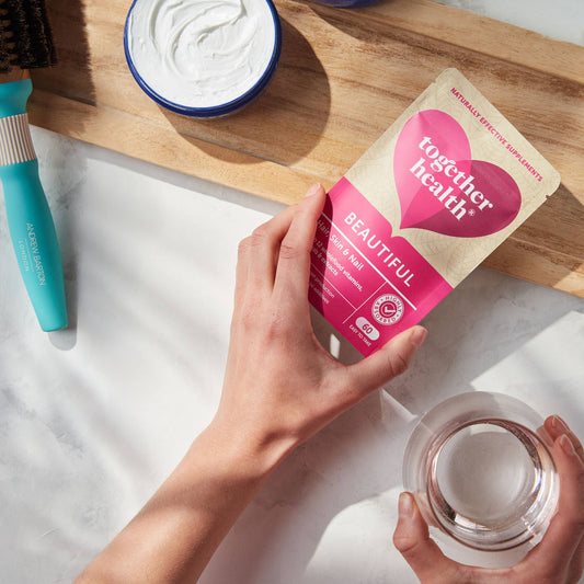 Hairbrush, Face cream, and glass.  Lady hands holding a packet of beautiful tablets.