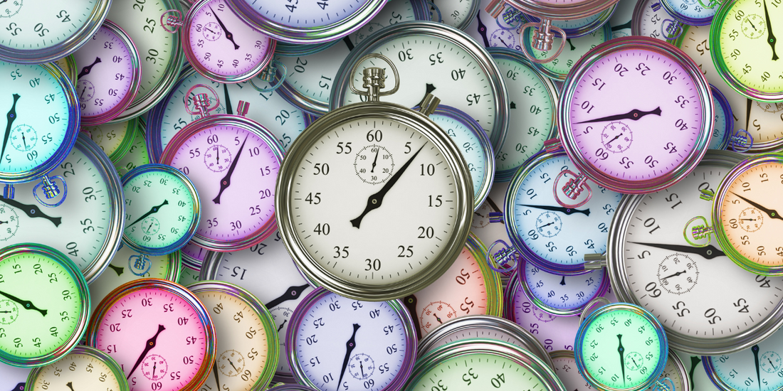 Lots of colourful stop watches all sitting on one another.