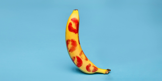 A banana with red lipstick kisses all over.