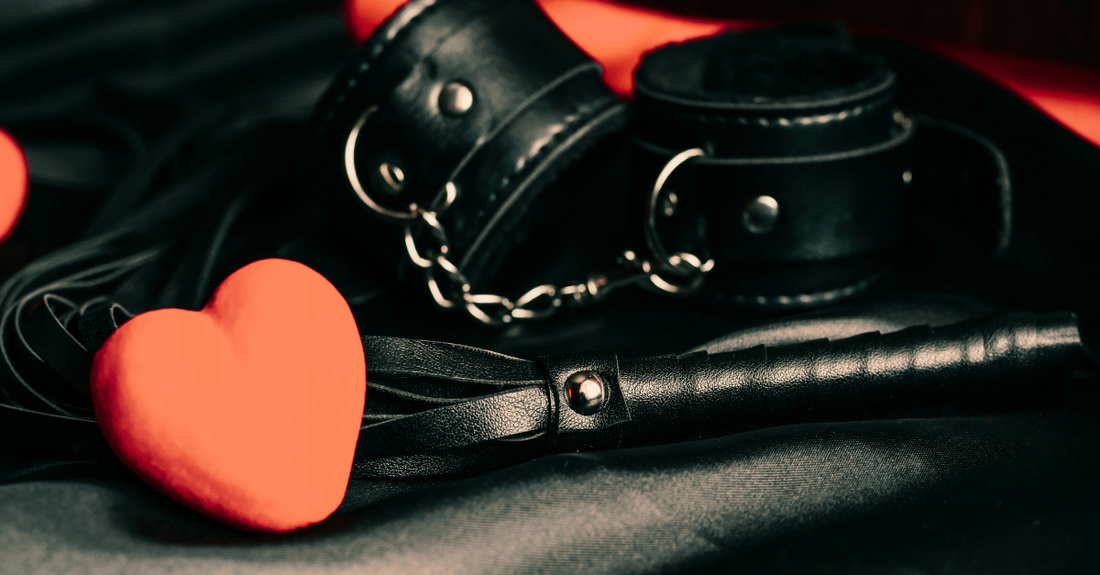 handcuffs and a whip with some love hearts