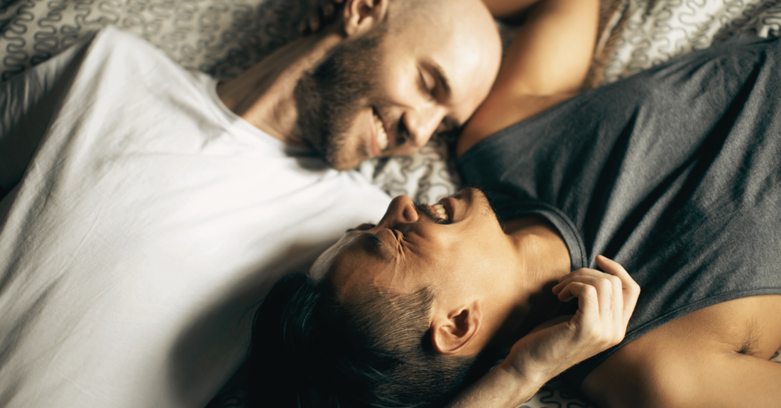 2 men looking at each other on bed