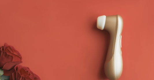 a travel size adult toy on a red background with roses