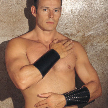 man wearing Black Arm Gauntlet With Rivets on stone wall. image 1
