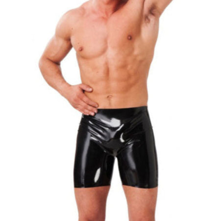 man wearing black latex bermuda shorts on white background. image 1