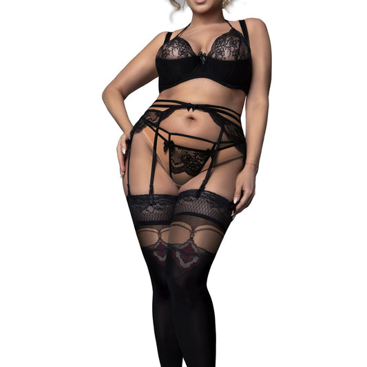 Lady wearing black lace holdups, with black bra on white background.