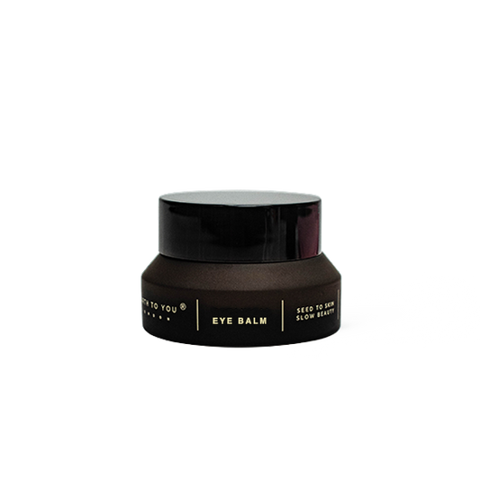 Black eye balm jar on a white background