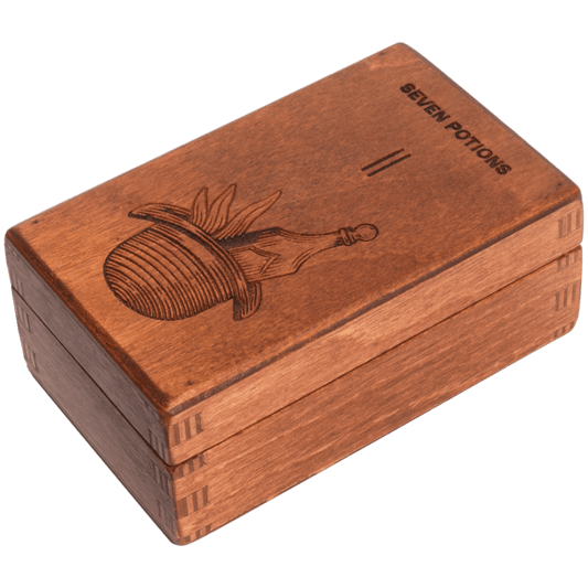 Wooden box with engraved design and 'Seven Potions' text on a white background