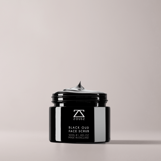 Black jar of ZOUSZ Black Oud Face Scrub on a light gray background