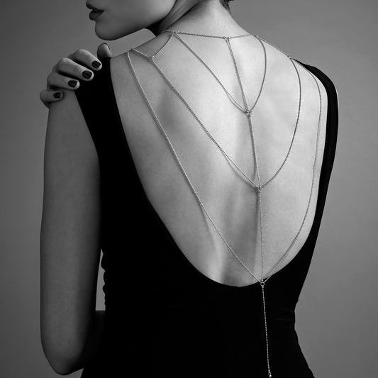 lady wearing back gold chain and black dress on a grey background. image 2