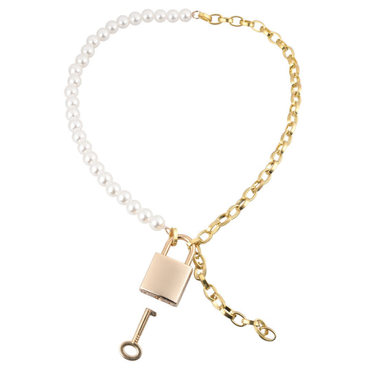 Gold and pearly day necklace on white background with lock and key. image 1
