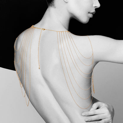 lady wearing gold shoulder chains on white and black background. image 1