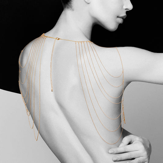 lady wearing gold shoulder chains on white and black background. image 1