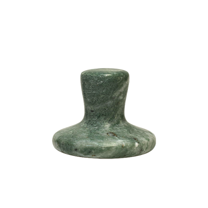 Green stone object on a white background