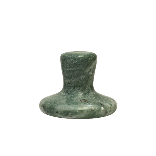 Green stone object on a white background