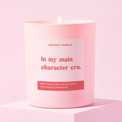 Pink candle with a label on a pink background